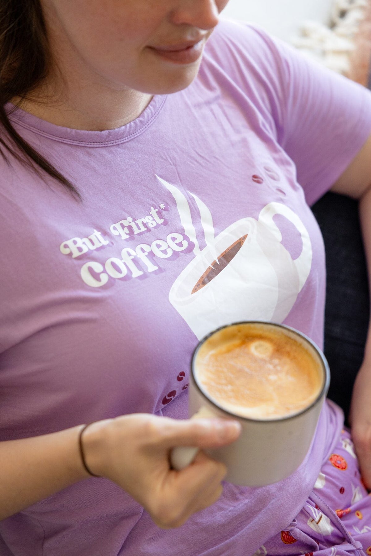 Woman wearing the Rest Day PJ But First Coffee lilac pyjama set, relaxed pose