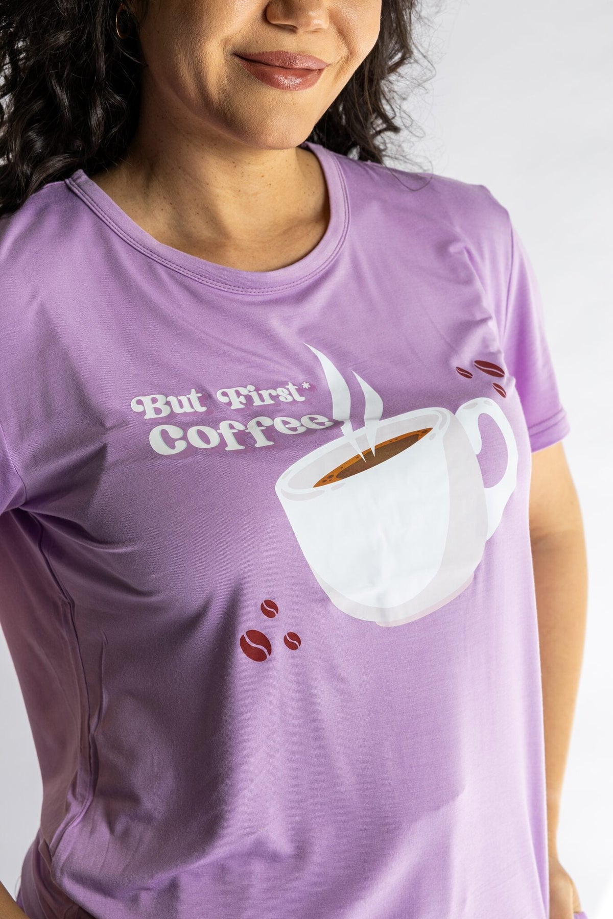 Woman wearing the Rest Day PJ But First Coffee lilac pyjama set, close-up of the But First Coffee tee