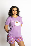 Woman wearing the Rest Day PJ But First Coffee lilac pyjama set, front view