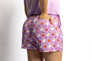 Woman wearing the Rest Day PJ But First Coffee lilac pyjama set, back view of the coffee print shorts