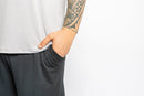 Man wearing the Rest Day PJ F.I.T. grey pyjama t-shirt and shorts set, charcoal shorts detail