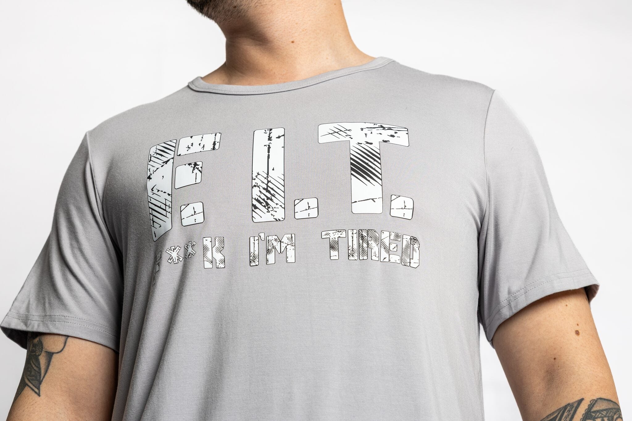 Man wearing the Rest Day PJ F.I.T. grey pyjama t-shirt and shorts set, close-up of the F.I.T. print tee