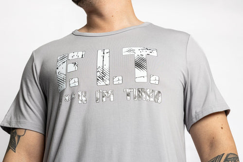 Man wearing the Rest Day PJ F.I.T. grey pyjama t-shirt and shorts set, close-up of the F.I.T. print tee