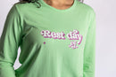 Model wearing the Rest Day PJ Signature green long-sleeve recovery pyjama set, close-up of the Rest Day PJ logo