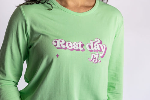 Model wearing the Rest Day PJ Signature green long-sleeve recovery pyjama set, close-up of the Rest Day PJ logo