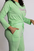 Model wearing the Rest Day PJ Signature green long-sleeve recovery pyjama set, soft micromodal fabric close-up