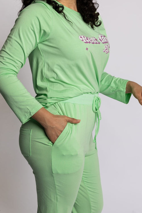 Model wearing the Rest Day PJ Signature green long-sleeve recovery pyjama set, soft micromodal fabric close-up