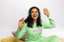 Model wearing the Rest Day PJ Signature green long-sleeve recovery pyjama set, full set on model