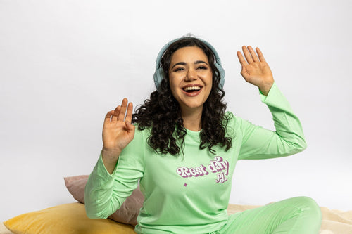 Model wearing the Rest Day PJ Signature green long-sleeve recovery pyjama set, full set on model