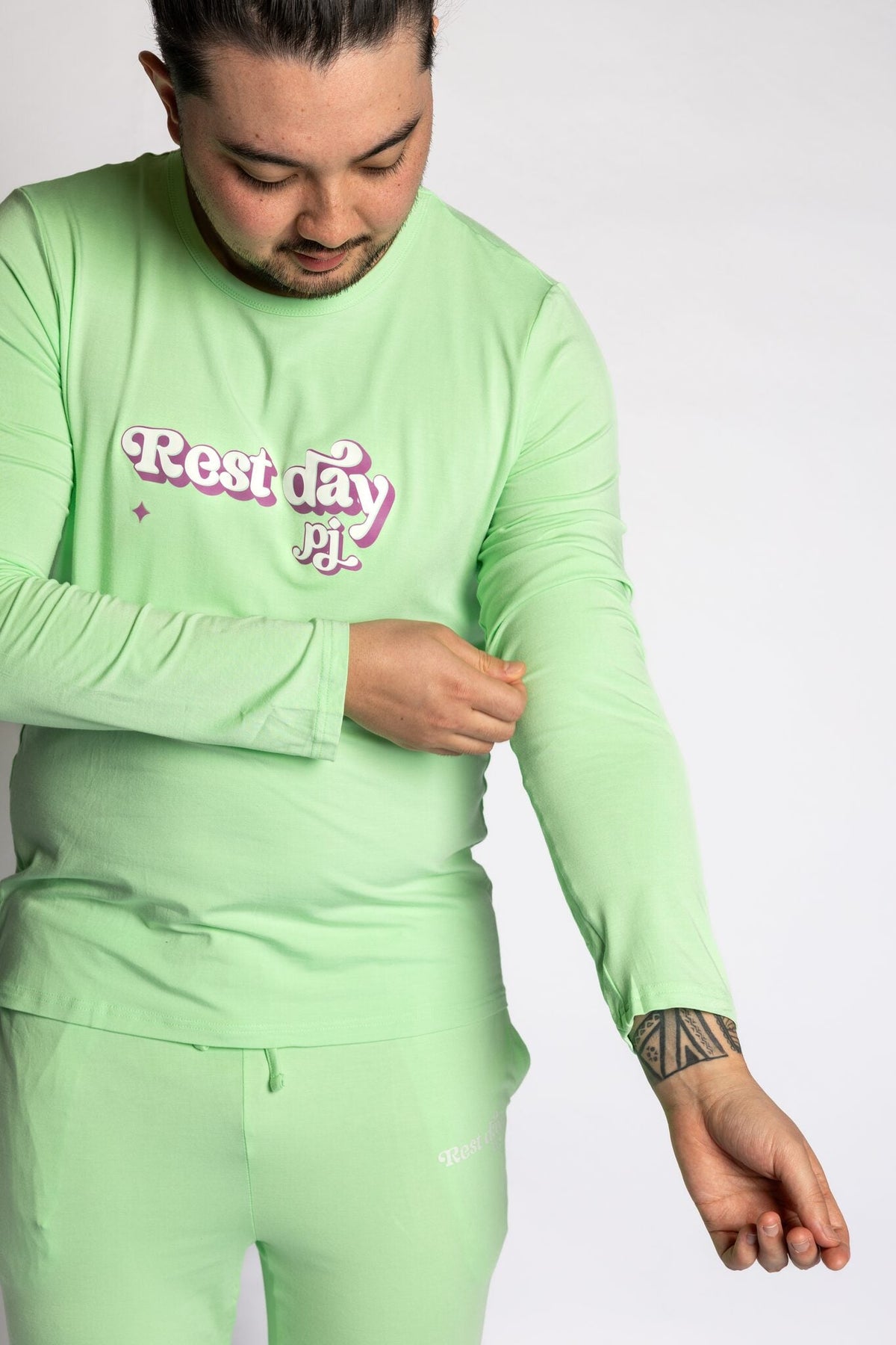 Model wearing the Rest Day PJ Signature green long-sleeve recovery pyjama set