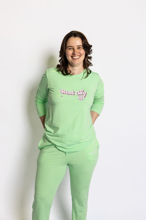 Model wearing the Rest Day PJ Signature green long-sleeve recovery pyjama set, front view