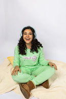 Model wearing the Rest Day PJ Signature green long-sleeve recovery pyjama set, full set on model